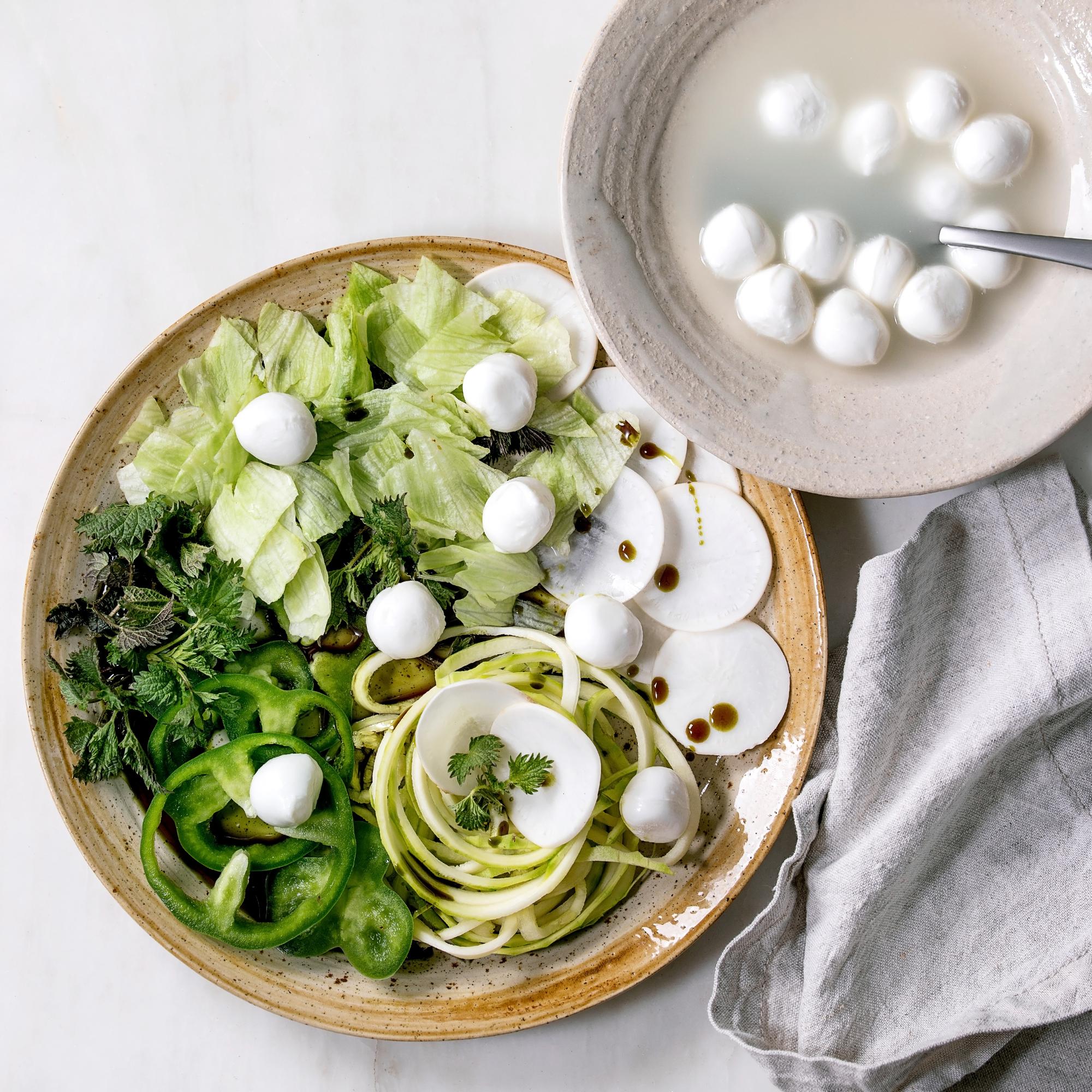 Large image of a plated seasonal salad with herbs